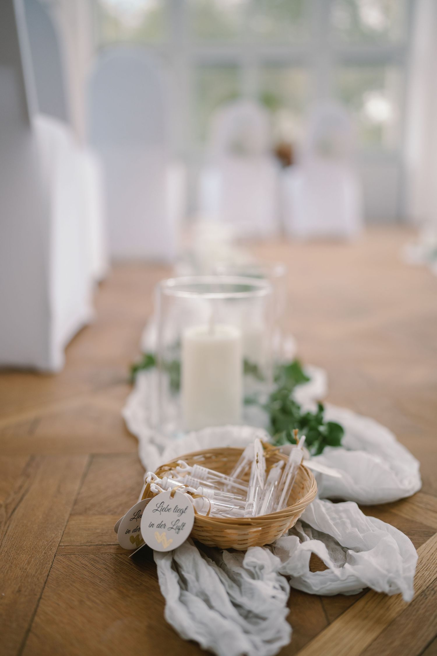White table settings with rustic decor and glassware arranged on a wooden surface.