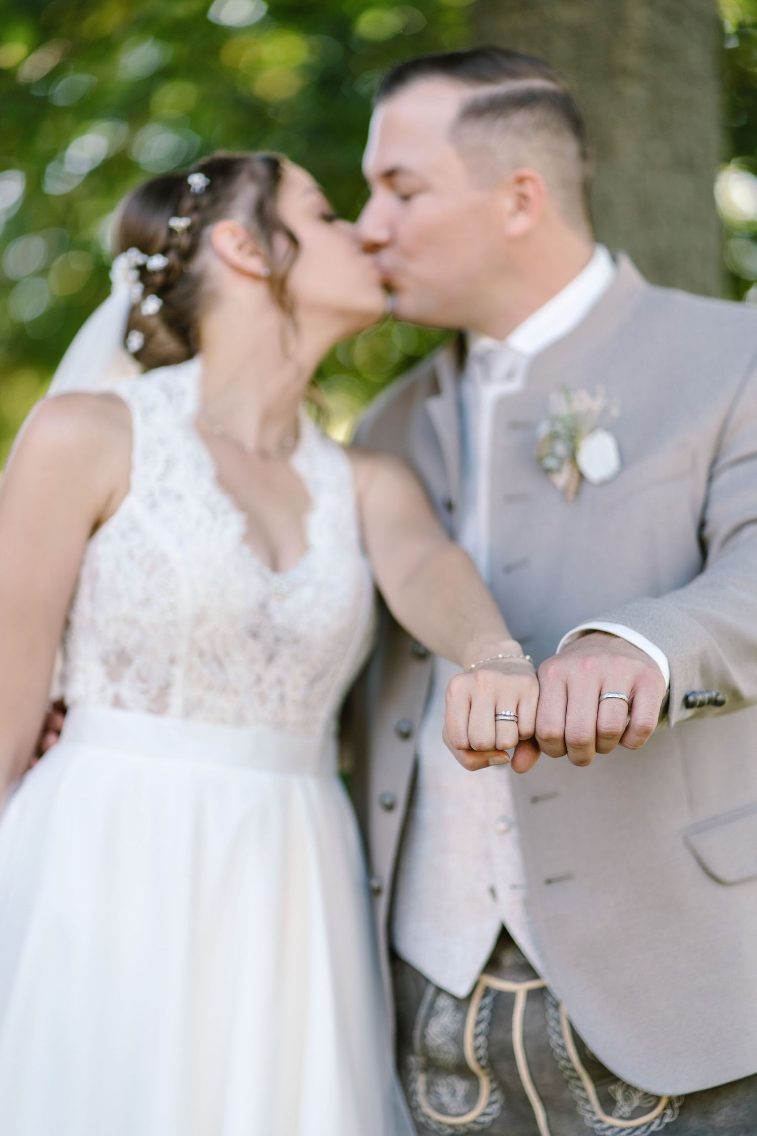 Intimate wedding portraits showing rings and tender moments in natural lighting.