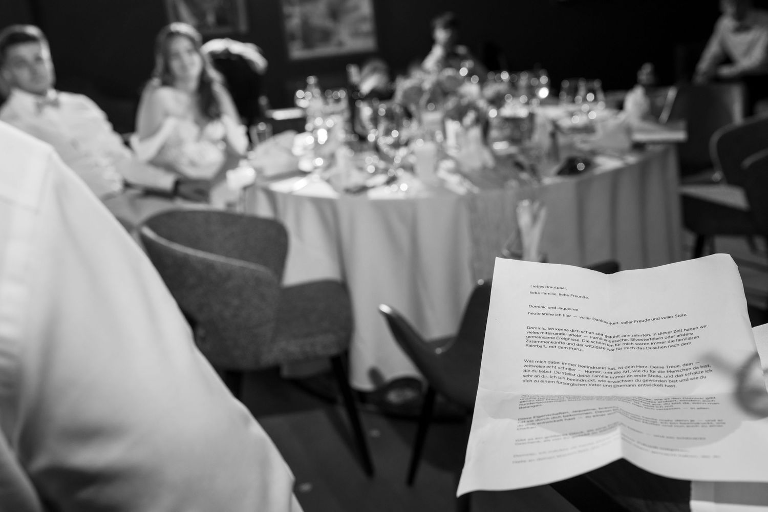 Wedding reception table settings with printed menus and place cards.