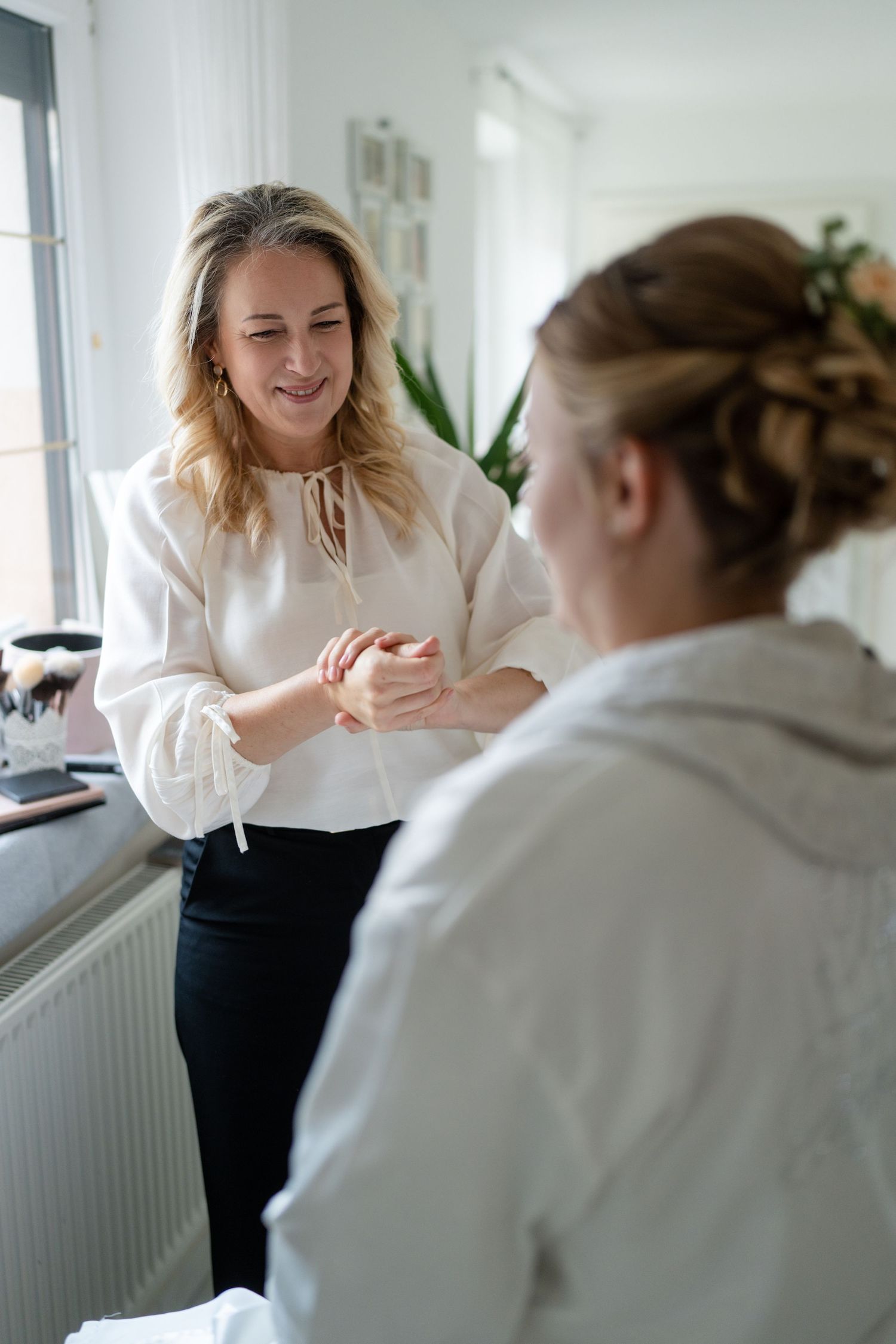 Two people in business attire having an animated conversation in a bright office setting.