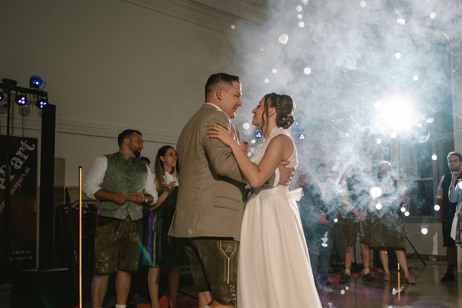 Wedding couple dancing surrounded by sparklers creating a magical atmosphere at their reception.