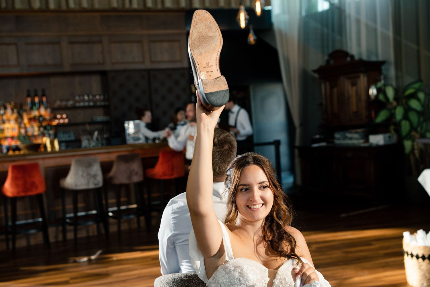 Guests dancing and celebrating at an elegant indoor wedding reception.