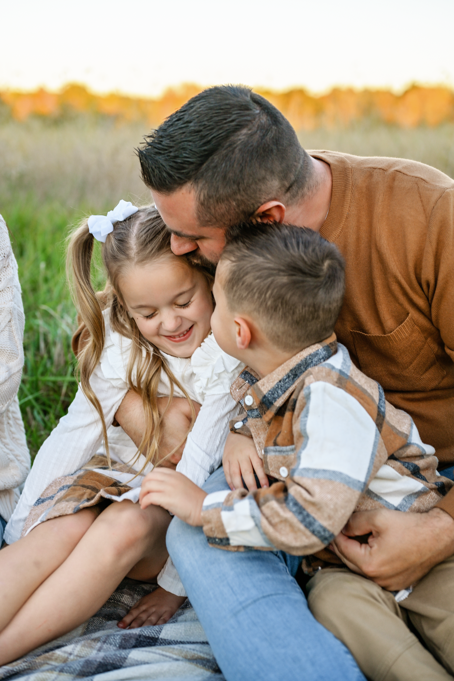 Candid family lifestyle photos showing intimate moments in an outdoor setting.