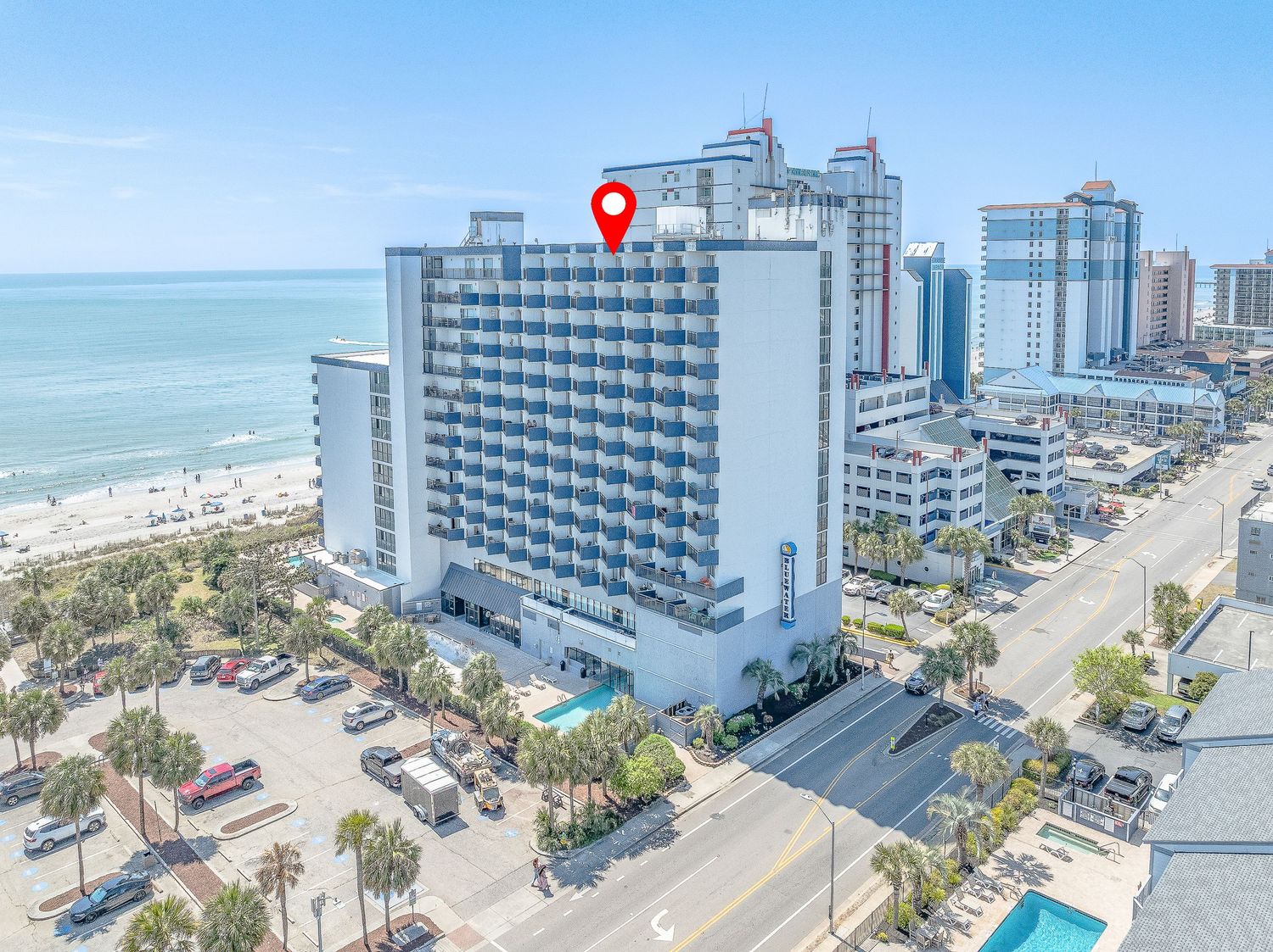 Aerial view of oceanfront high-rise hotel in Myrtle Beach with beach and city views.