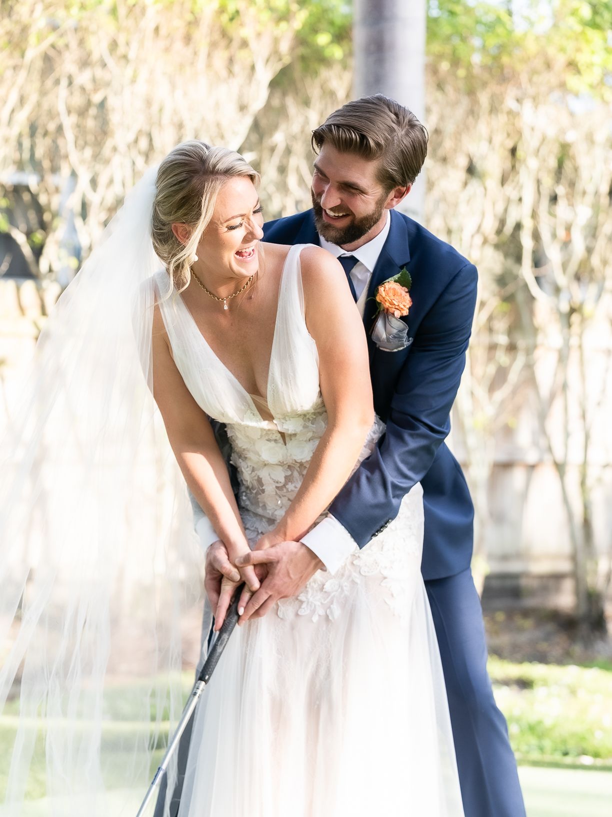 A couple in wedding attire share joyful moments together in a romantic outdoor setting.