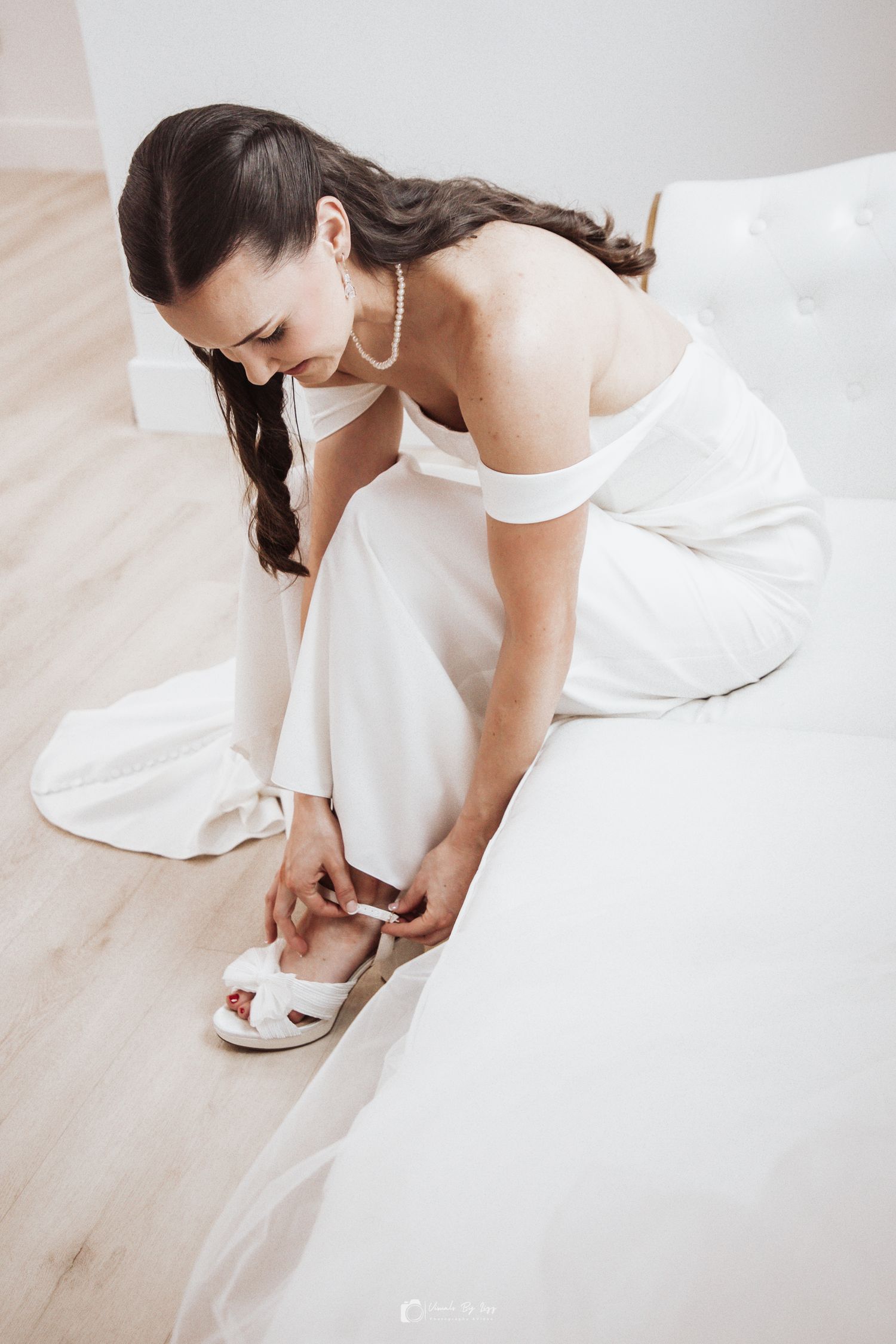 Bride putting on wedding shoes at Whitewood Ranch, De Leon Springs FL — Visuals by Lizz, Treasure Coast wedding photographer