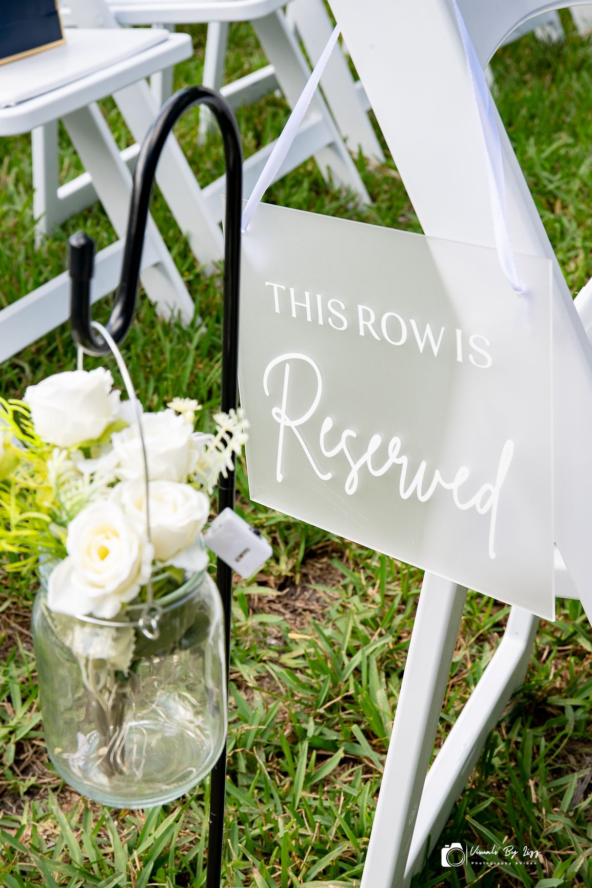 Reserved row sign and white floral detail at McKee Botanical Garden wedding, Vero Beach FL — Visuals by Lizz