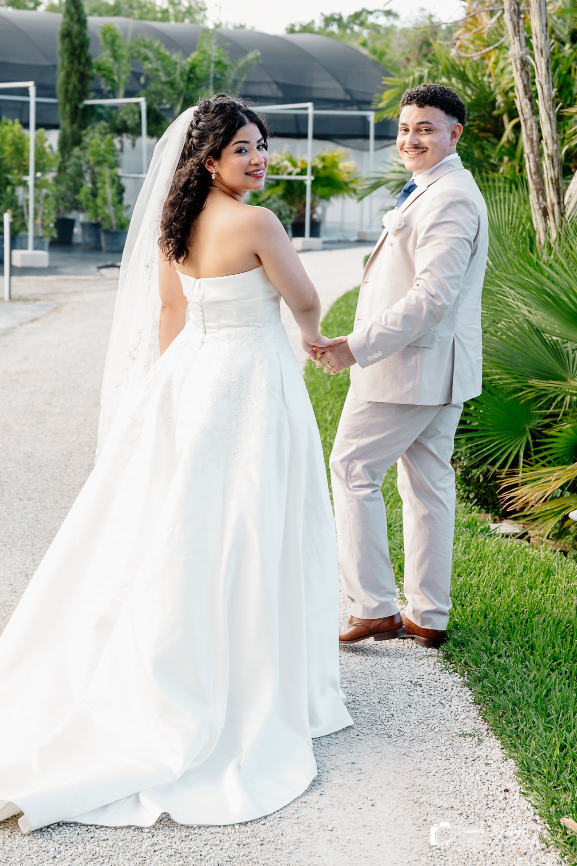 Bride and groom holding hands at McKee Botanical Garden wedding, Vero Beach FL — Visuals by Lizz, Treasure Coast wedding photographer