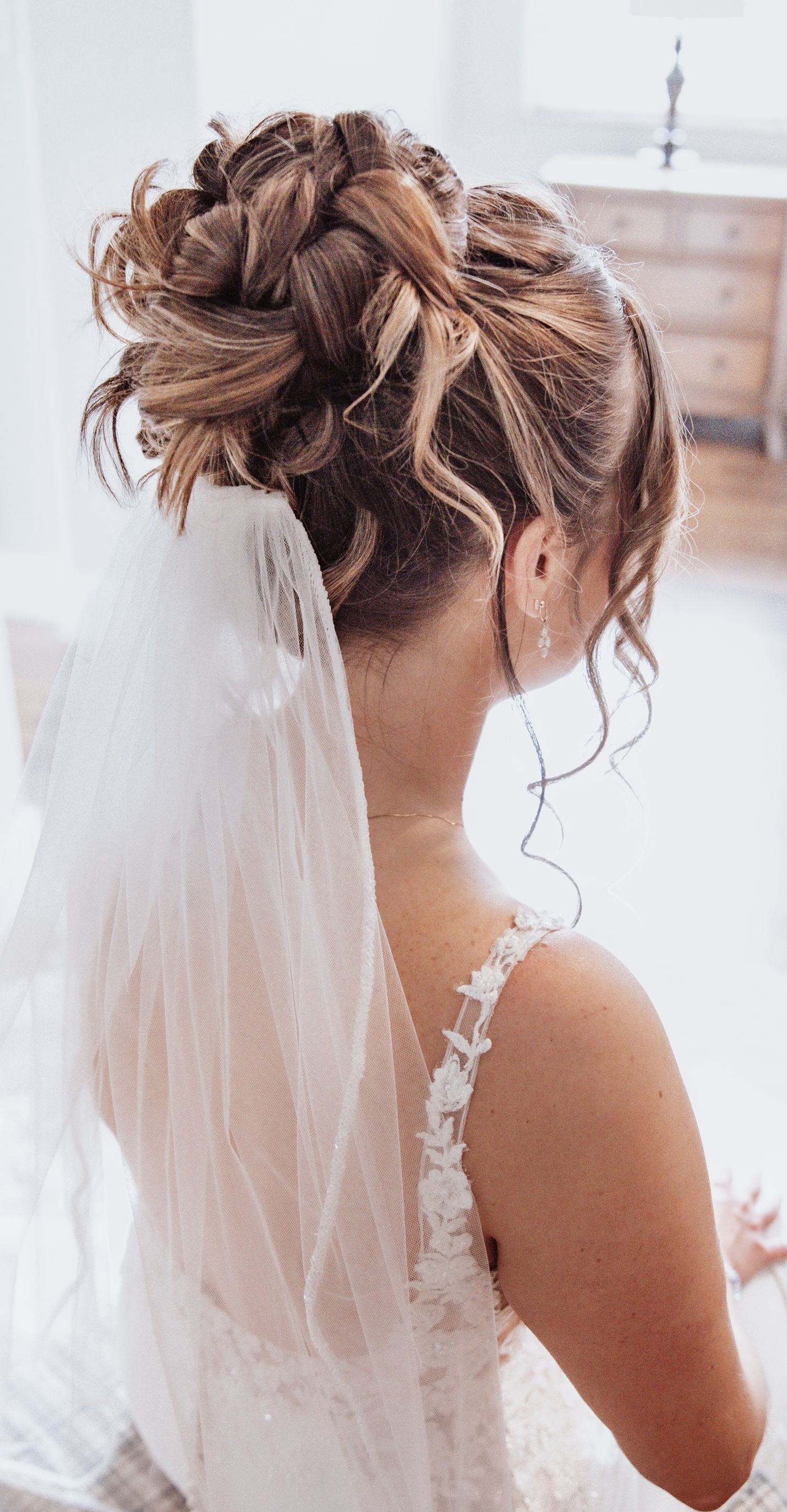 Bridal hairstyle details showing an elegant updo with flowing veil from different angles.