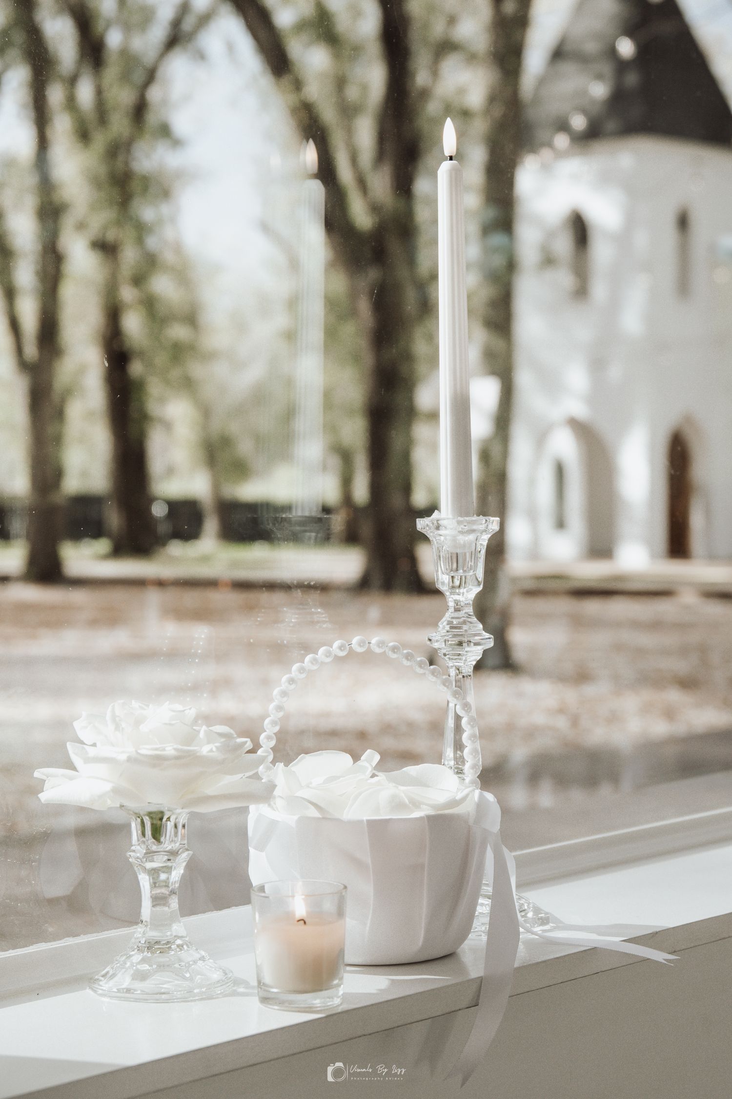 Elegant white wedding reception table settings with crystal glassware and candleholders in The Whitewood Ranch, De Leon Springs, FL