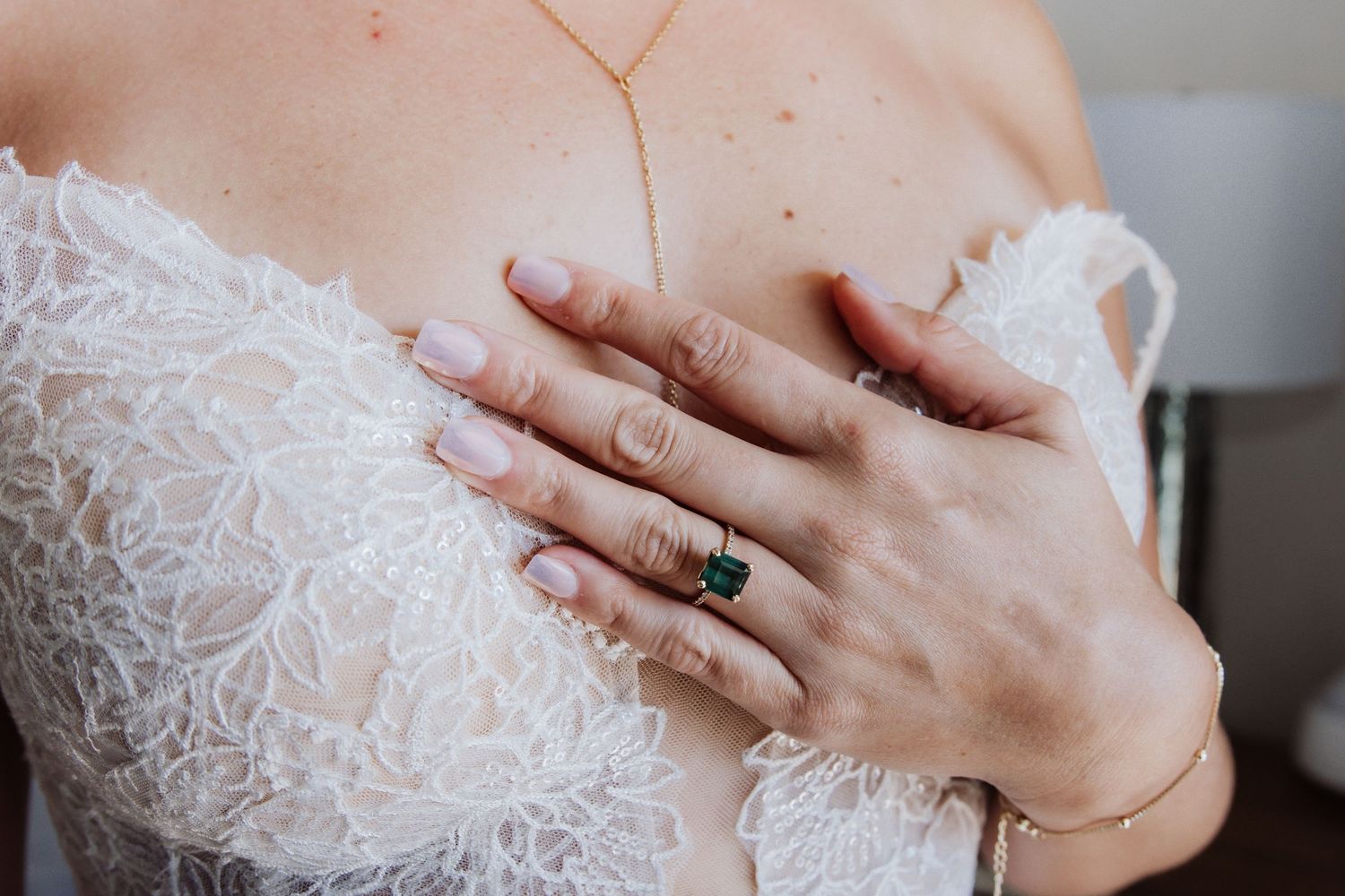 A close up series showing details of delicate white lace and hands wearing rings.