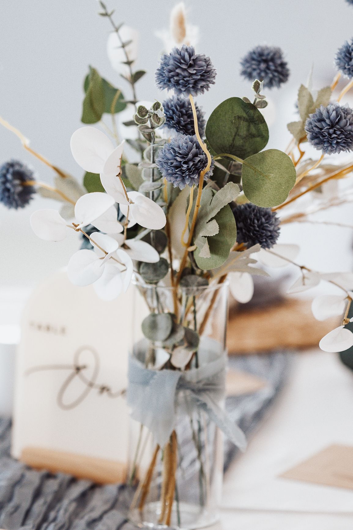 Blue thistle and eucalyptus floral centerpiece at Jensen Beach FL wedding — Visuals by Lizz, Treasure Coast wedding photographer