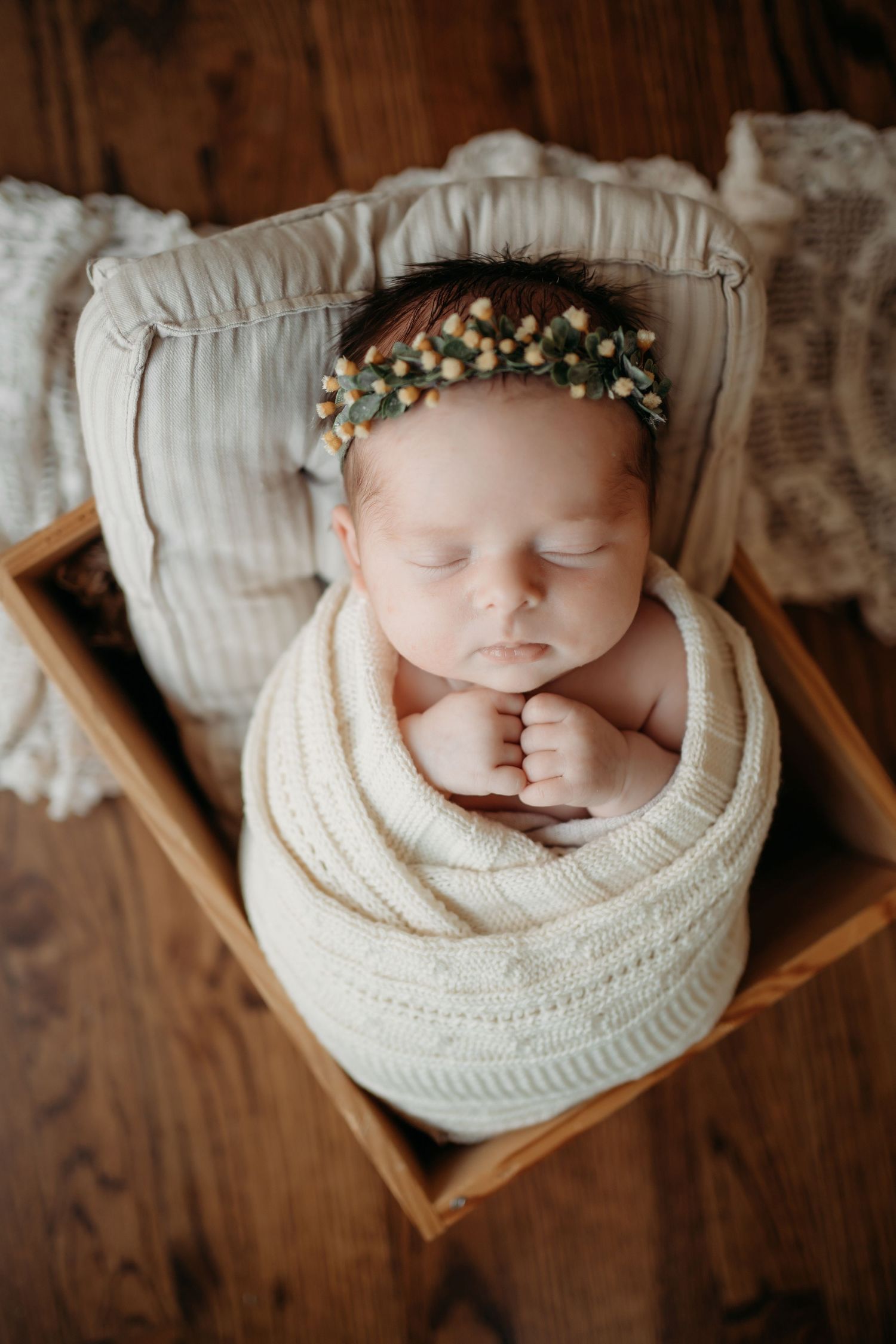 Sleeping newborn baby wrapped in blanket during Lawrence Kansas newborn photography session
