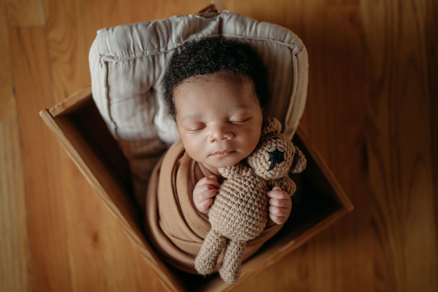 Sleeping newborn baby wrapped in blanket during Lawrence Kansas newborn photography session
