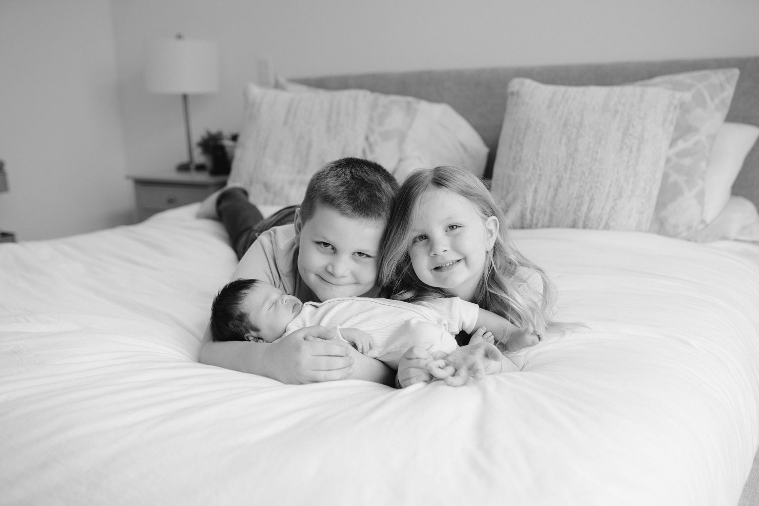 Lawrence Kansas newborn photographer capturing baby wrapped in blanket