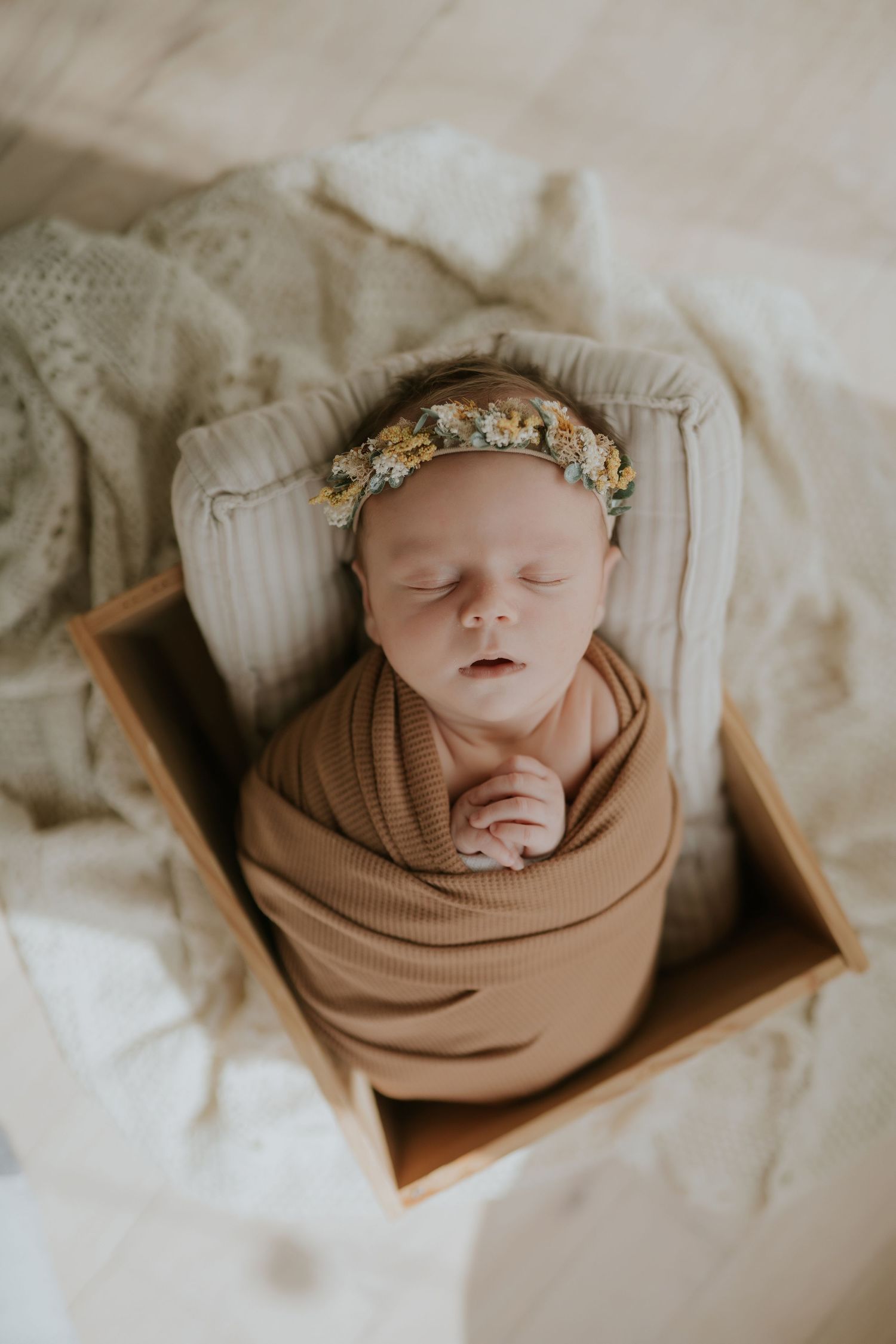 Lawrence Kansas newborn photographer capturing baby wrapped in blanket