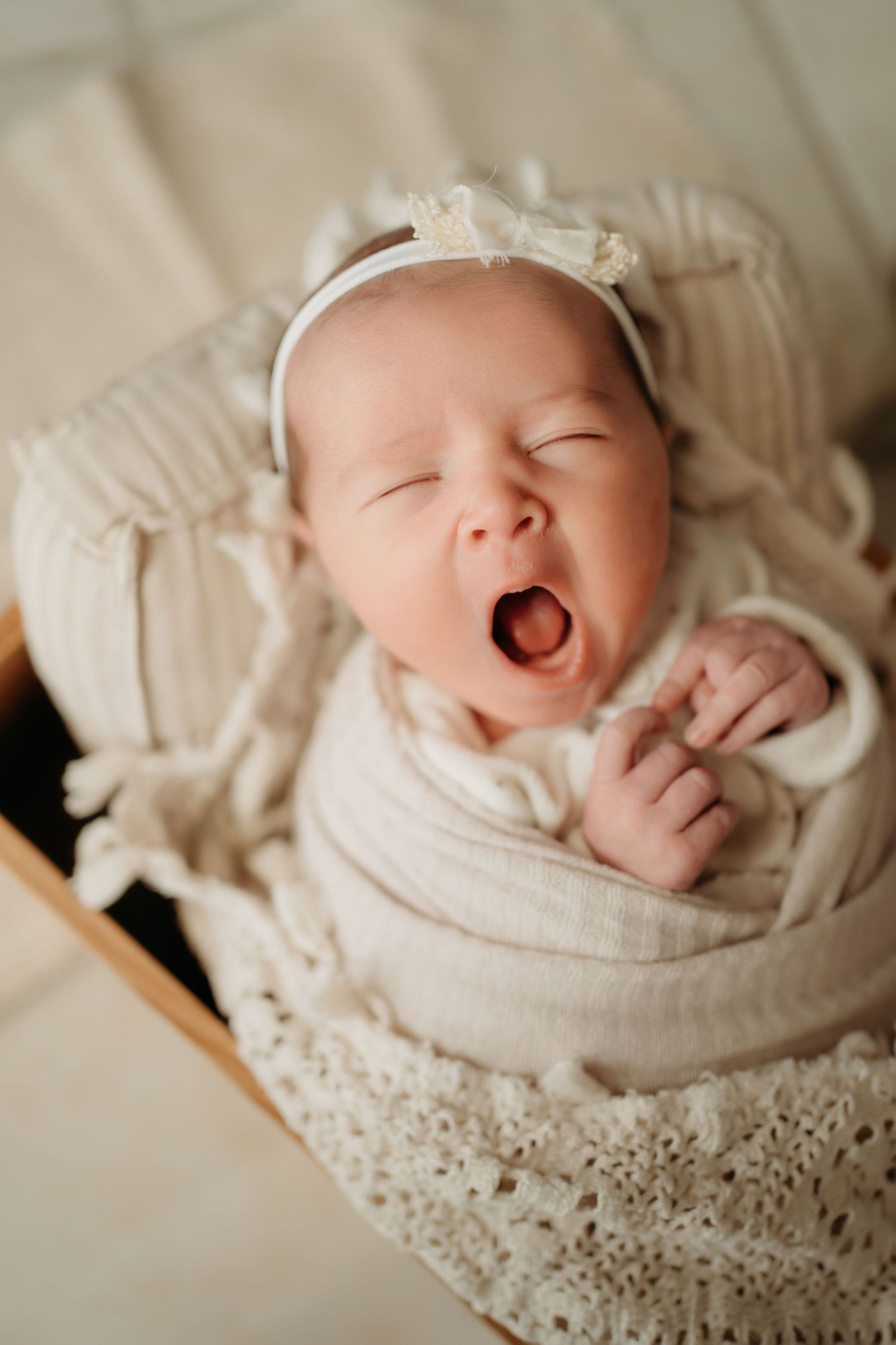 Sleeping newborn baby wrapped in blanket during Lawrence Kansas newborn photography session
