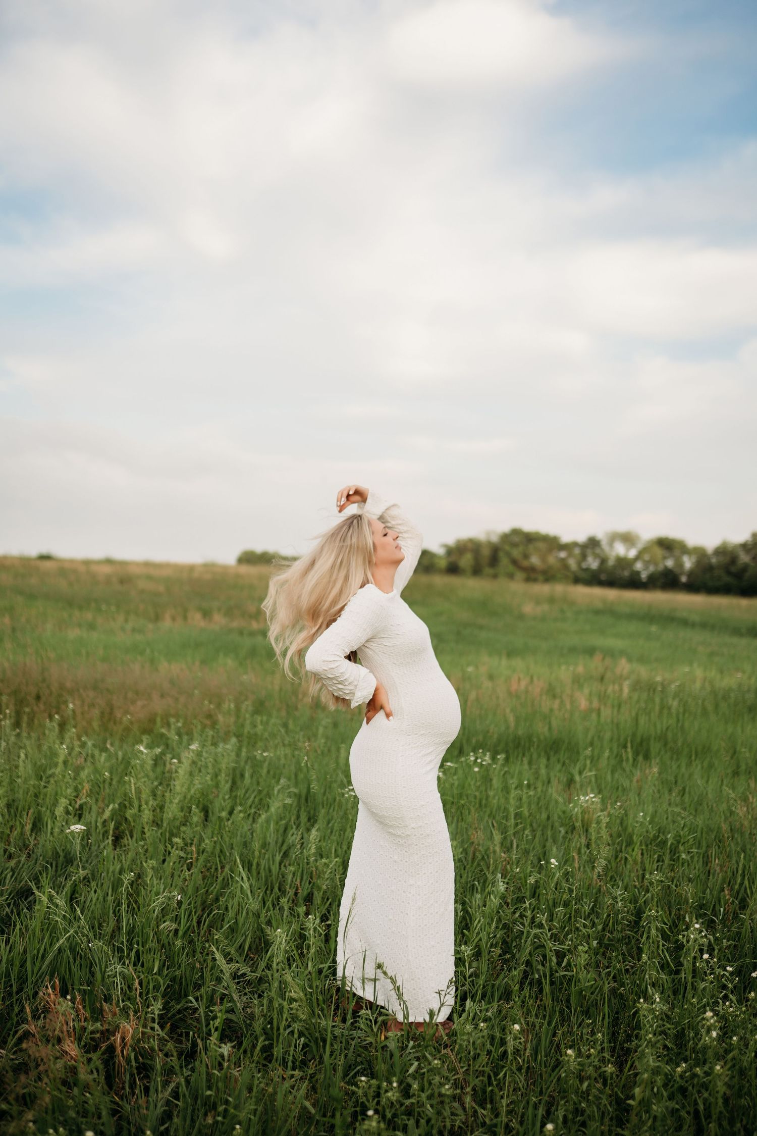 Pregnant mother standing in field during Lawrence Kansas maternity photography session