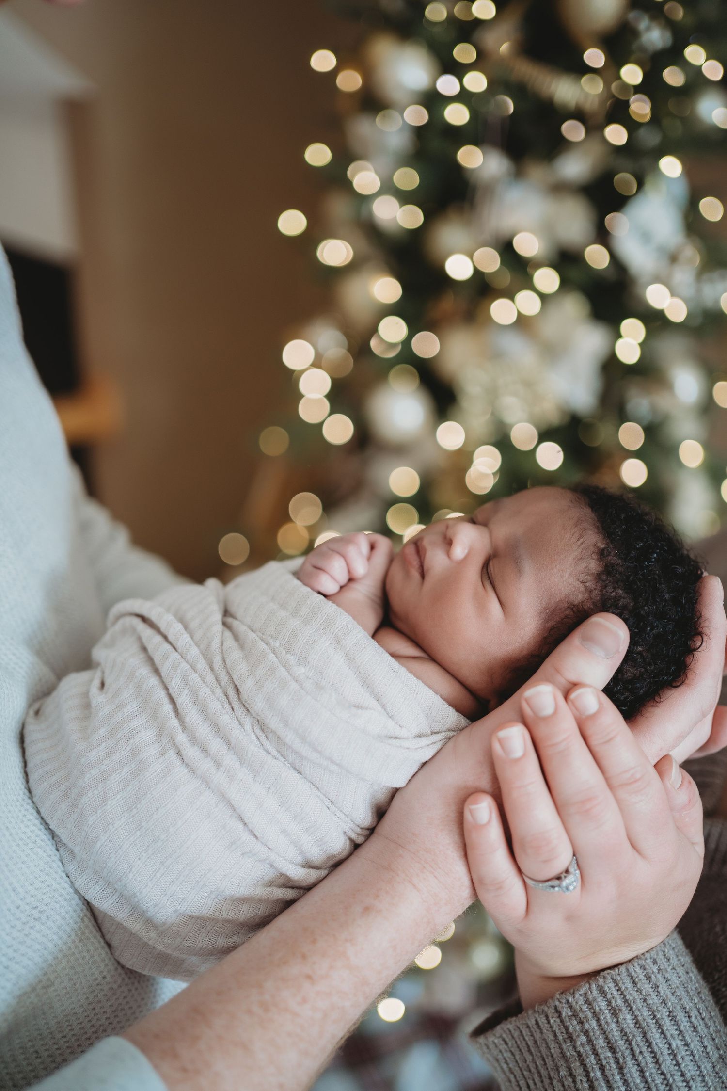Sleeping newborn baby wrapped in blanket during Lawrence Kansas newborn photography session