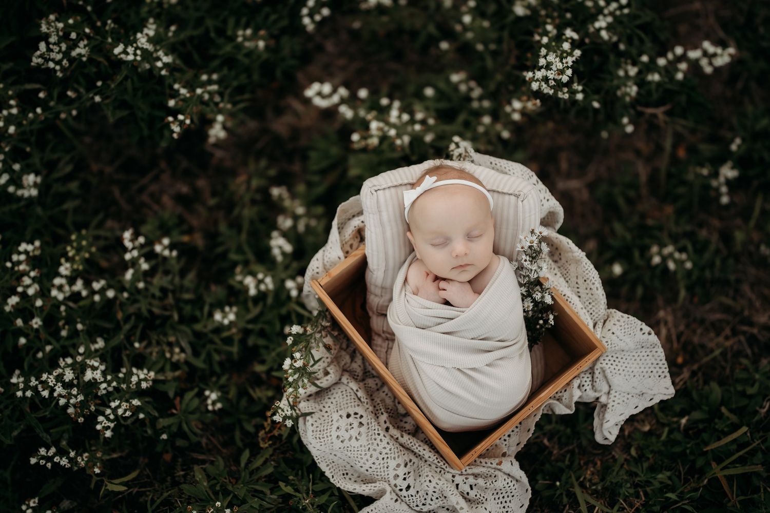 Sleeping newborn baby wrapped in blanket during Lawrence Kansas newborn photography session