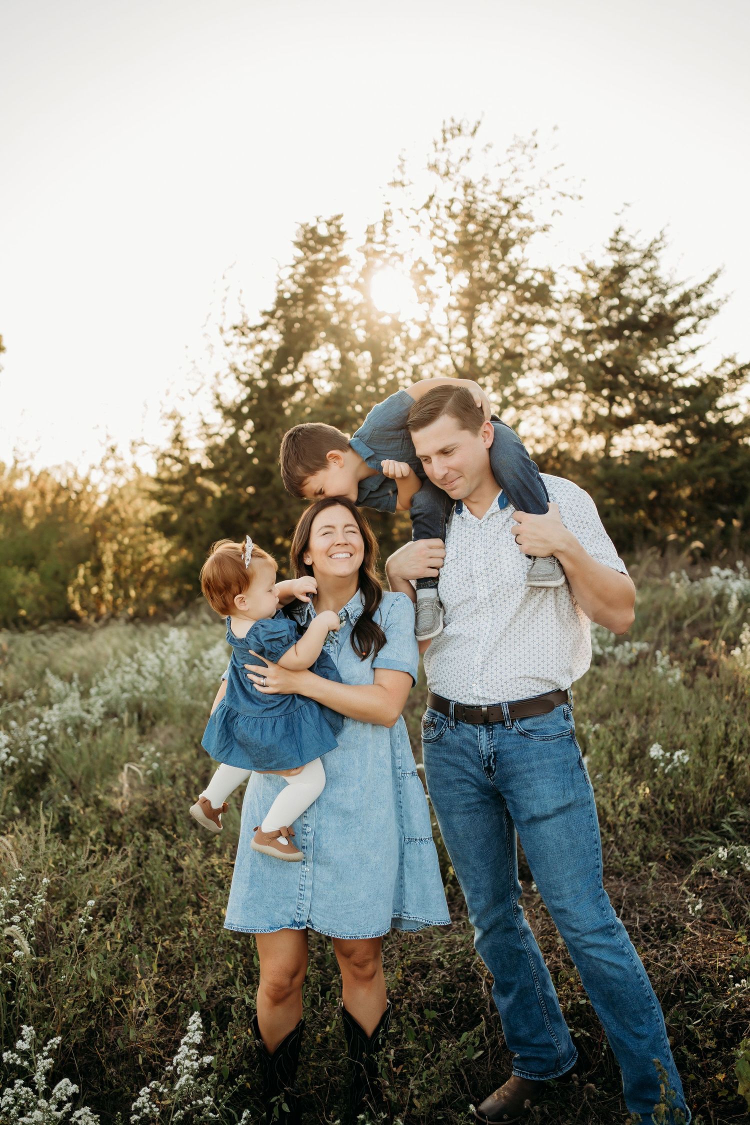 Natural family photography with parents and children in Kansas field