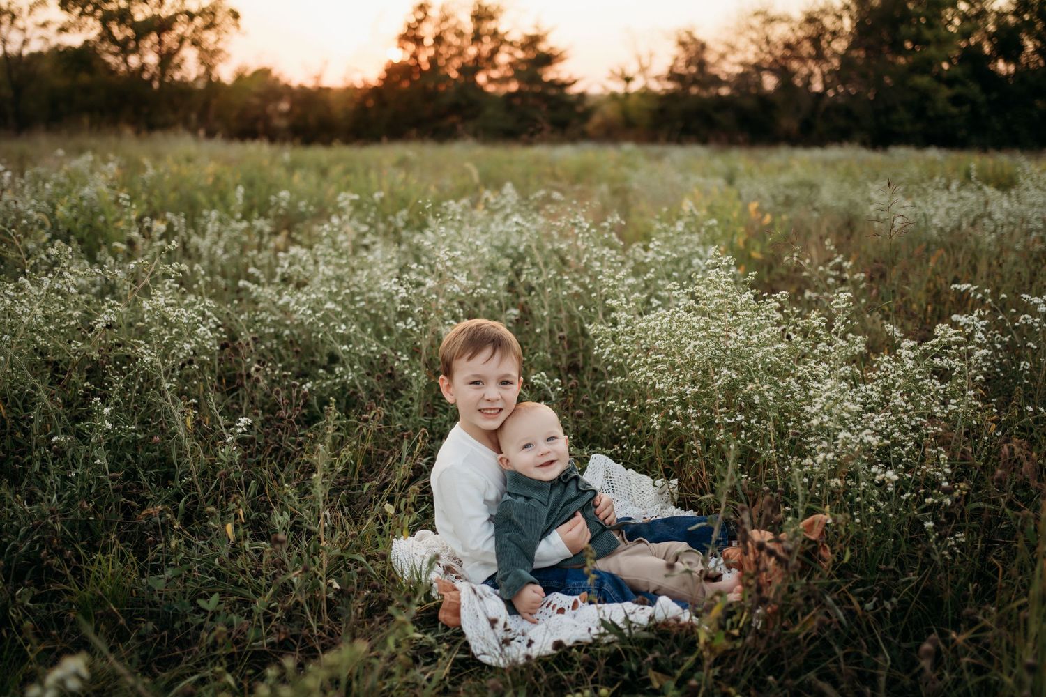 Big brother holding newborn baby during Lawrence Kansas newborn photography session