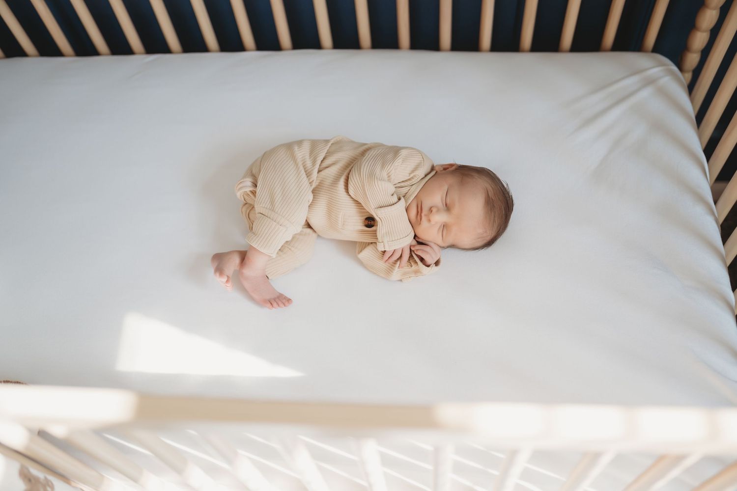 Newborn baby sleeping during soft natural newborn photography session