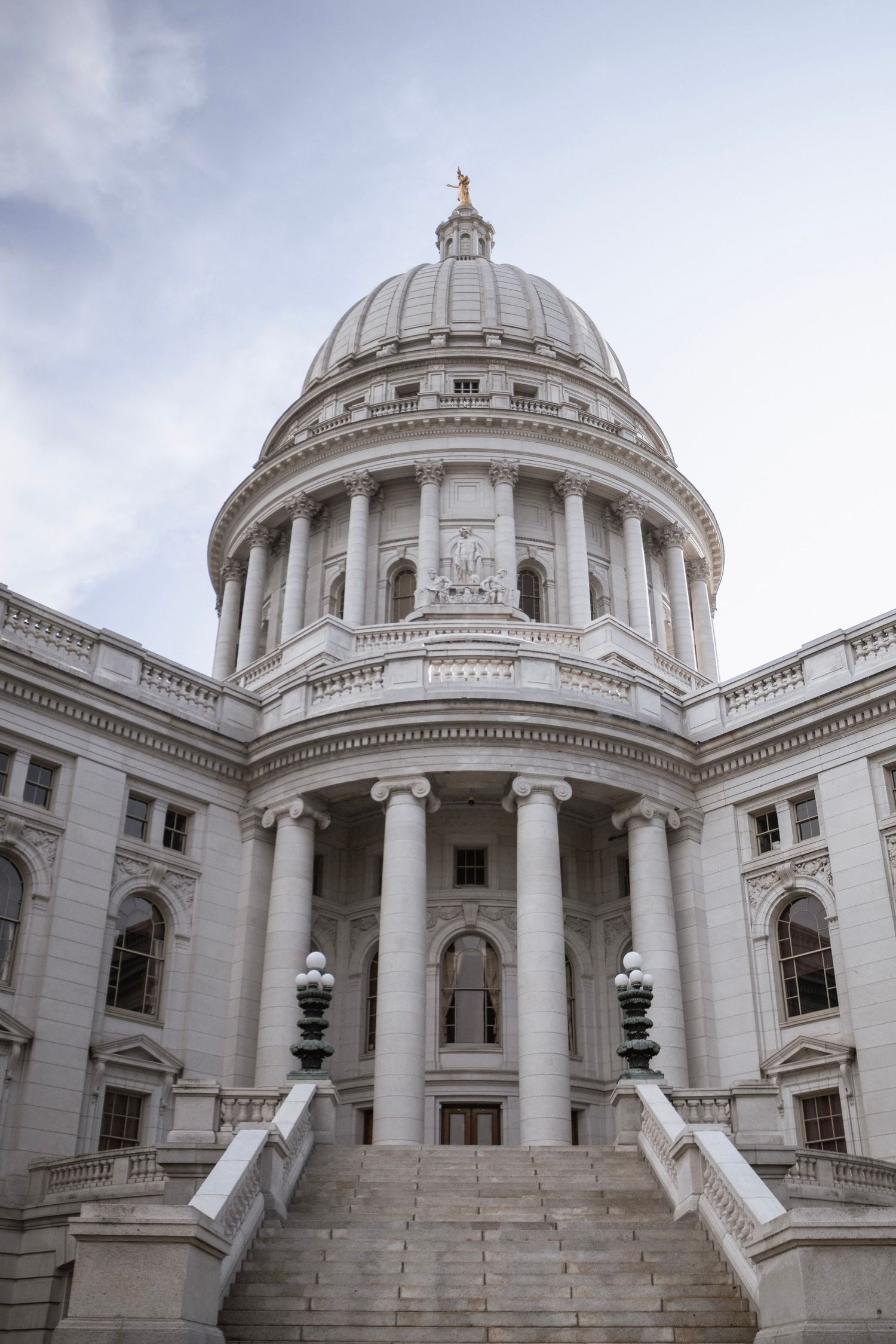 Wisconsin State Capitol building with white marble dome, Corinthian columns and grand staircase in Madison, Wisconsin.