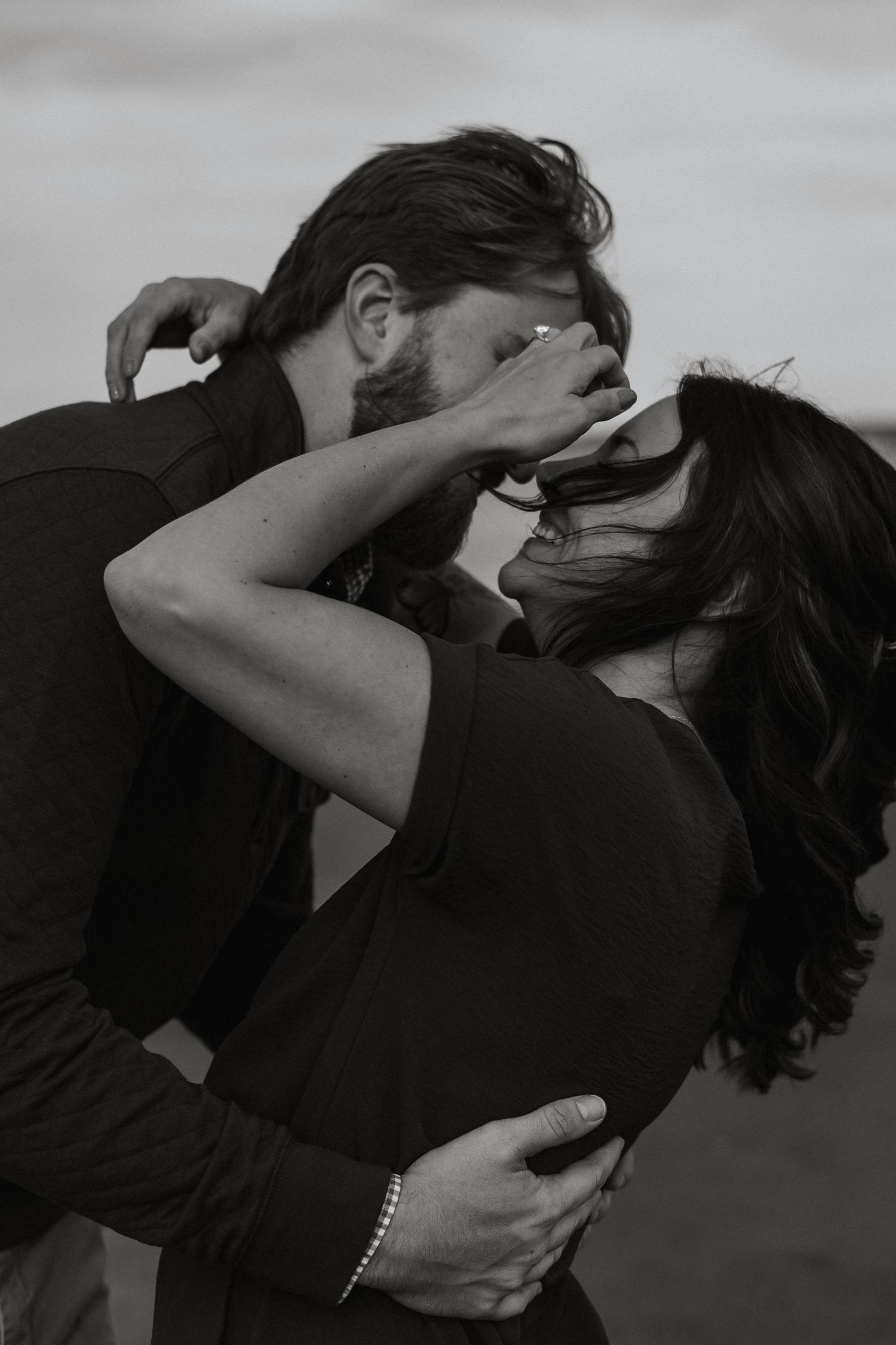 Two people embrace passionately in a black and white photo series showing progressive intimate movements.