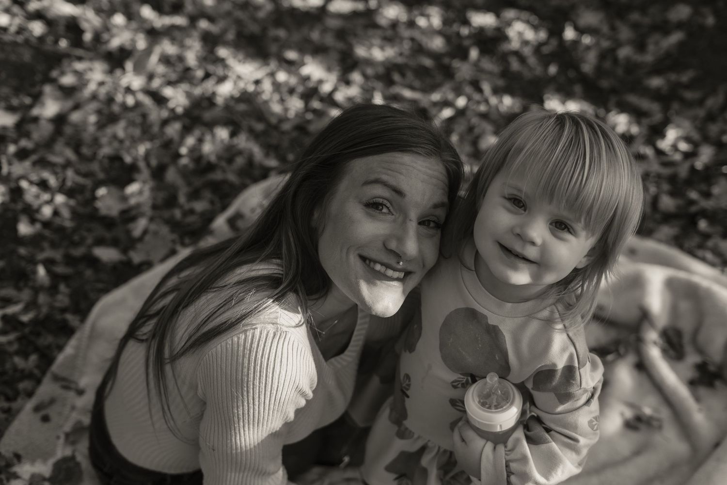 A heartwarming black and white moment captured between two people outdoors.