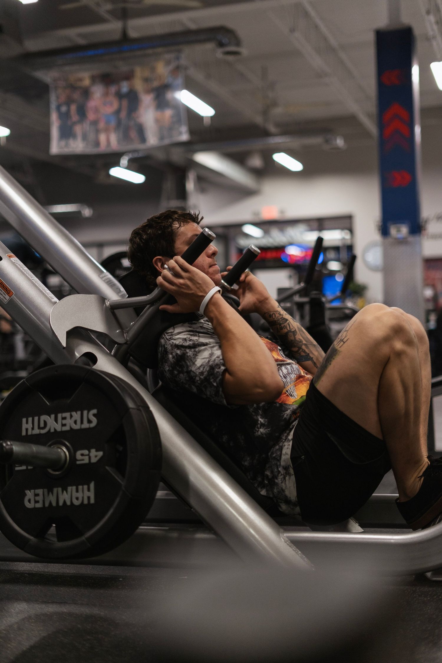Athlete performing hack squat in the gym.