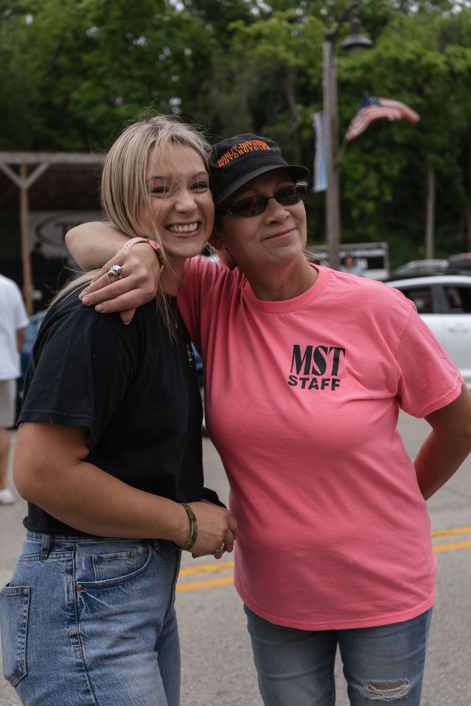 Woman smiling at the car show.