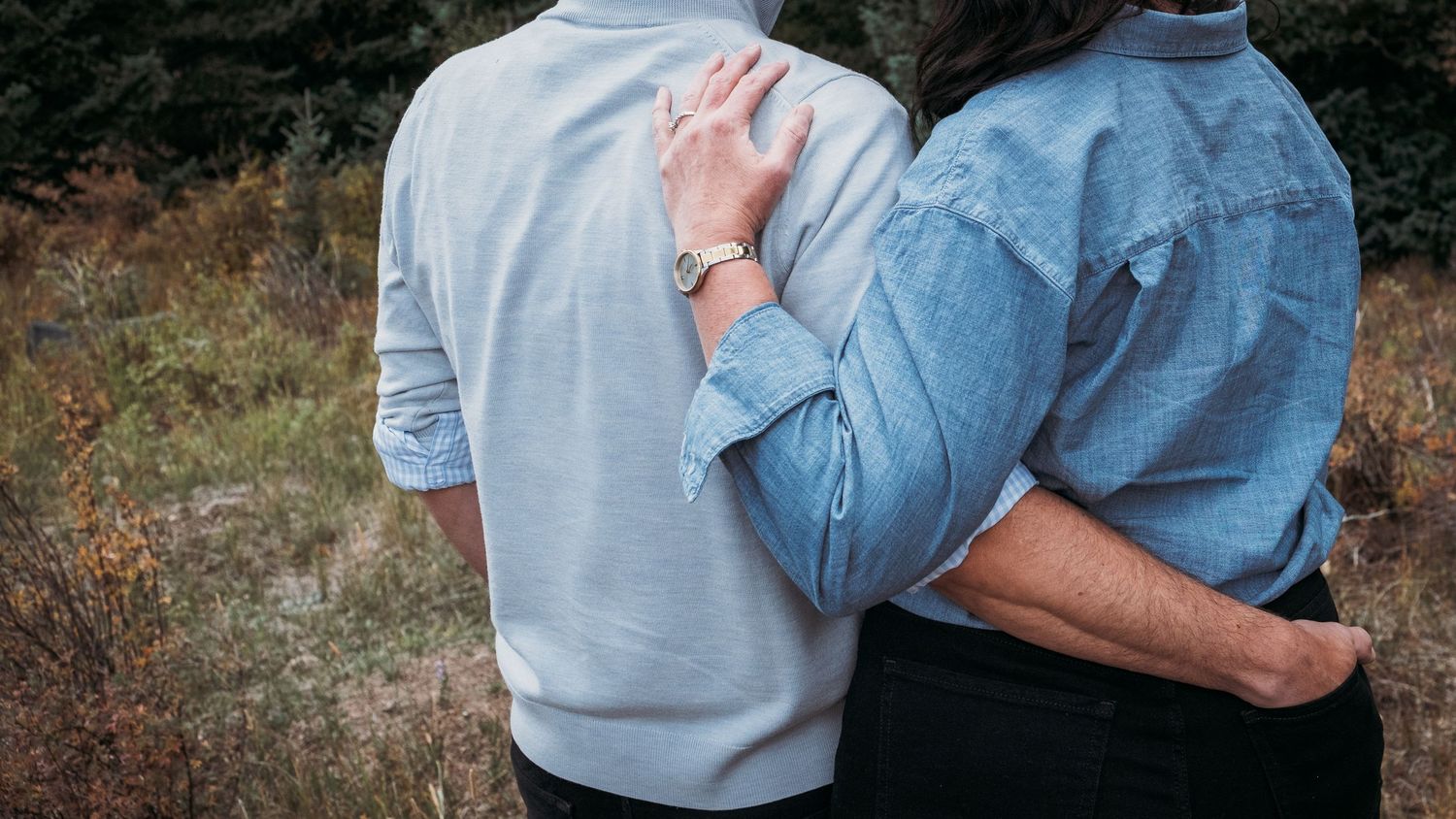 Close up of husband and wife standing closely together.