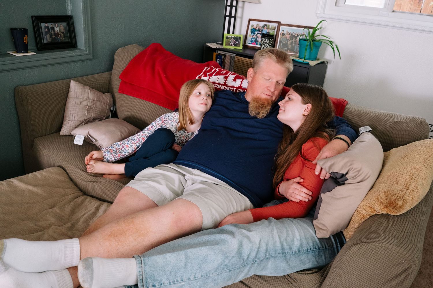In home Denver documentary portrait of family of four in living room.