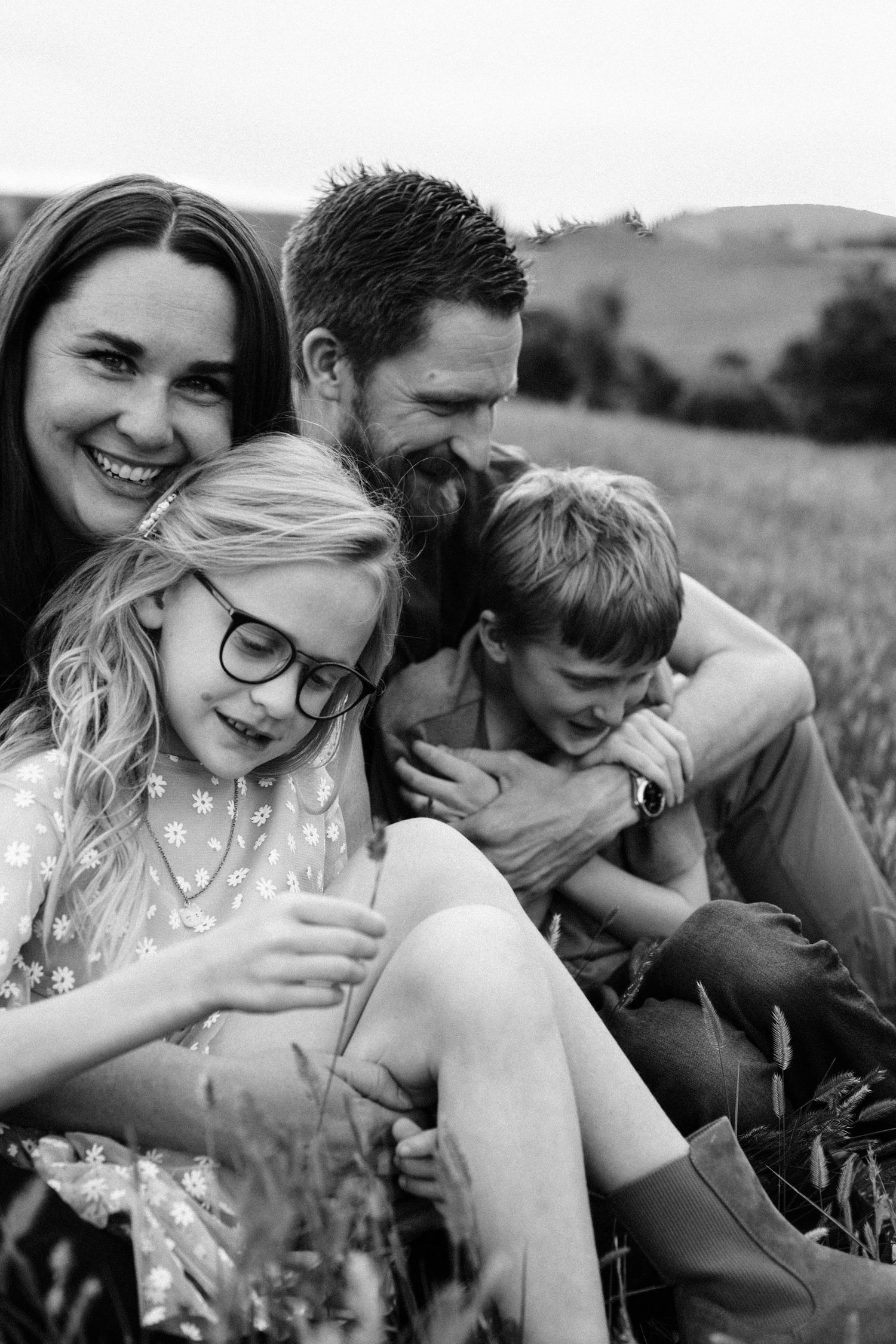 Black and white portrait of mother, father, and two children, in park at Littleton, Colorado.