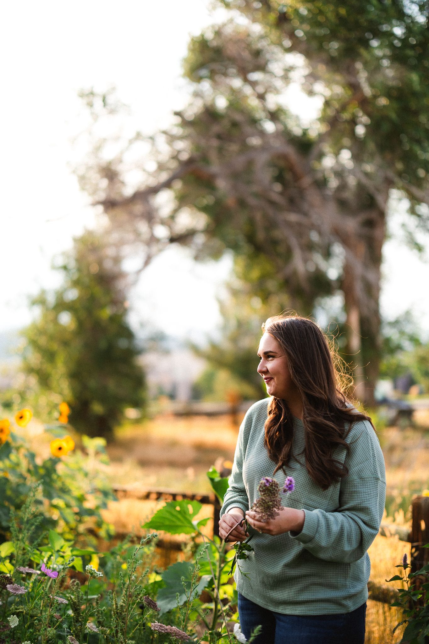 Portrait of Maggie of Maggie Theis Photography in her backyard garden.