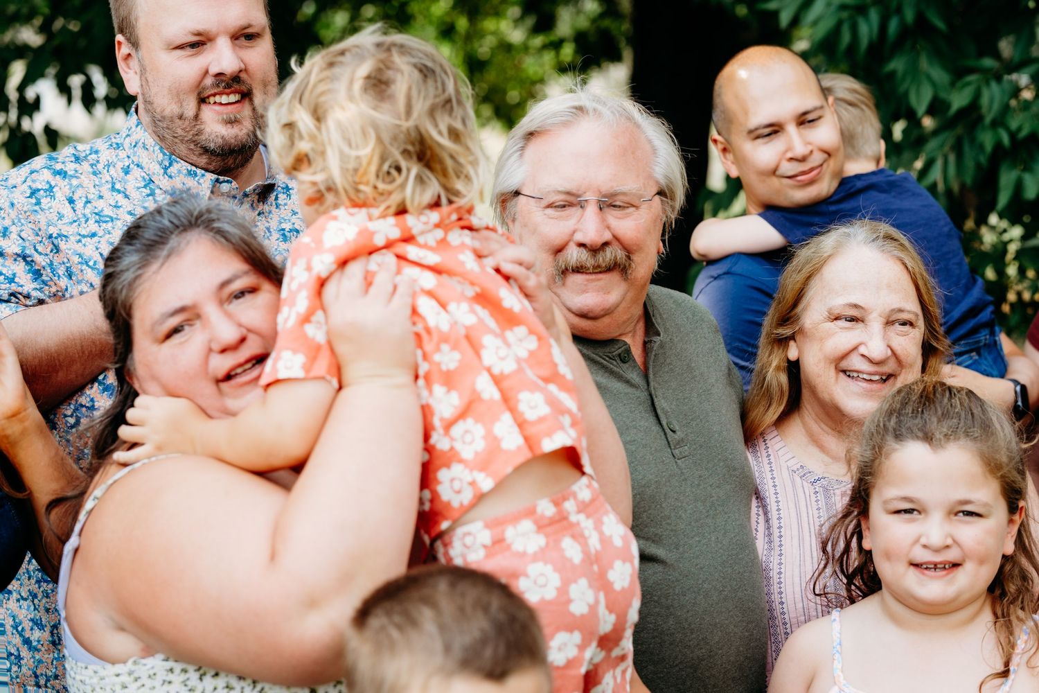 Documentary family photo of family in between posed portraits at extended family photo shoot.