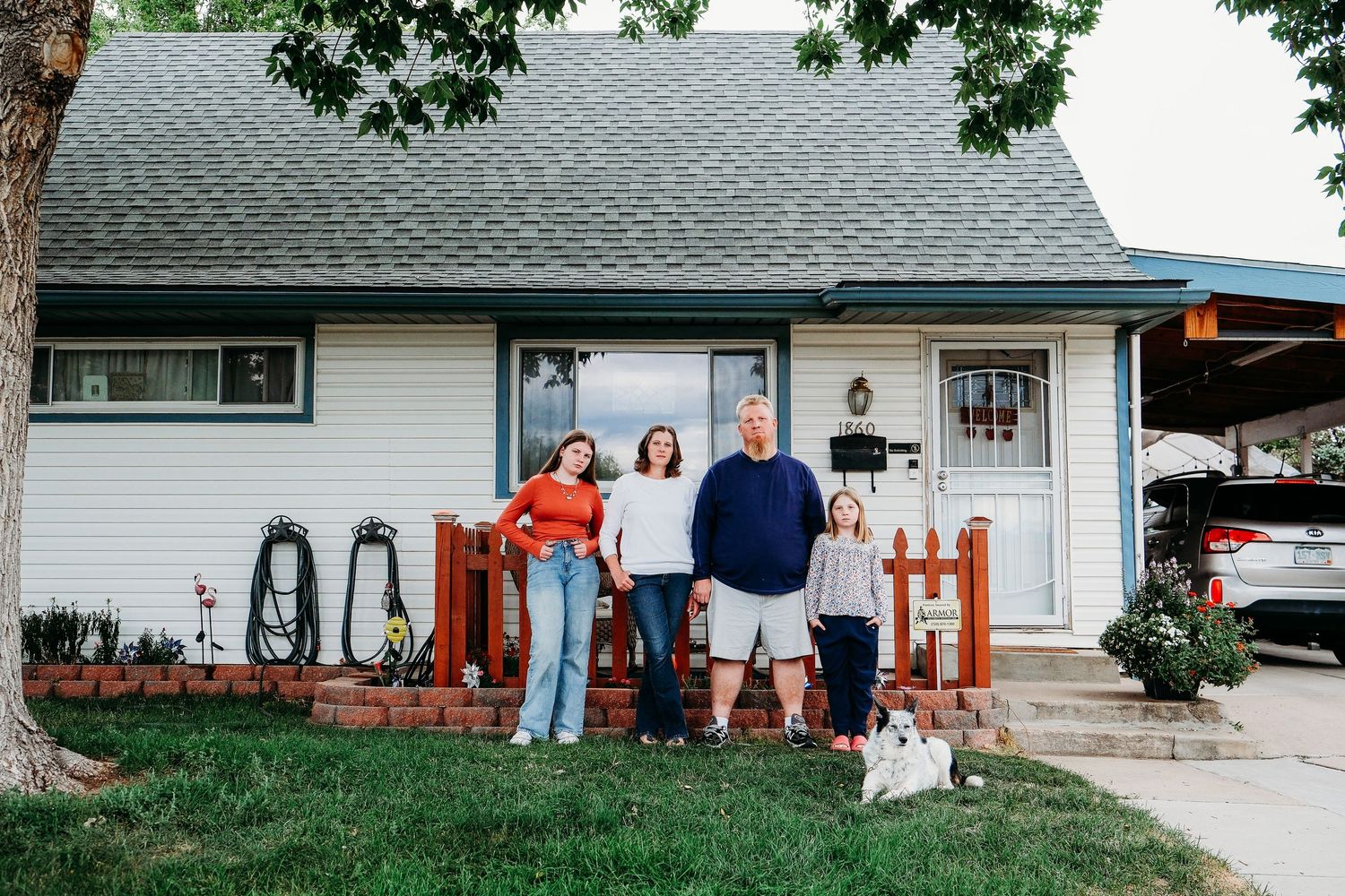 In-home Denver family photography session,  family of four in front yard of Denver home.