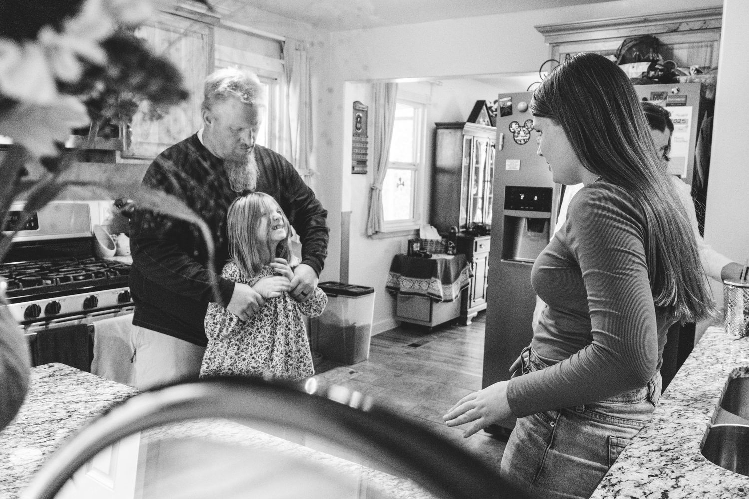 Denver family having a playful dance party in kitchen.