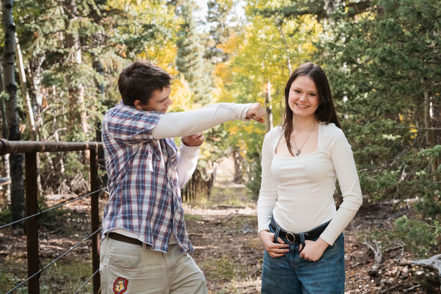 Playful portrait of siblings in forest near Colorado national park.