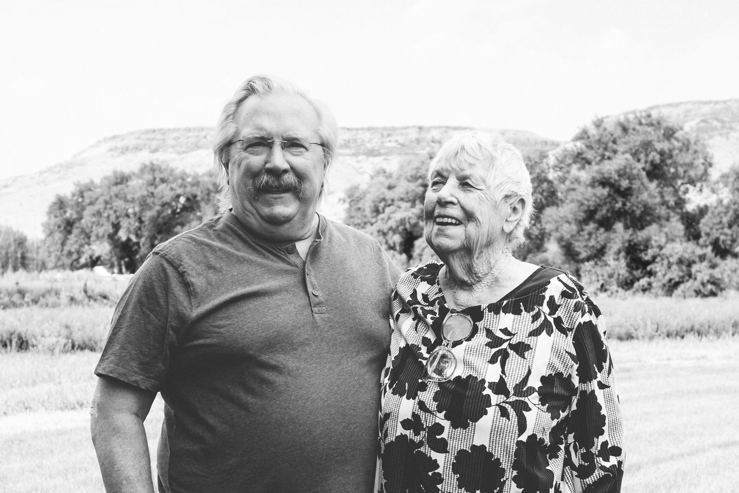 Father standing with mother, black and white portrait.