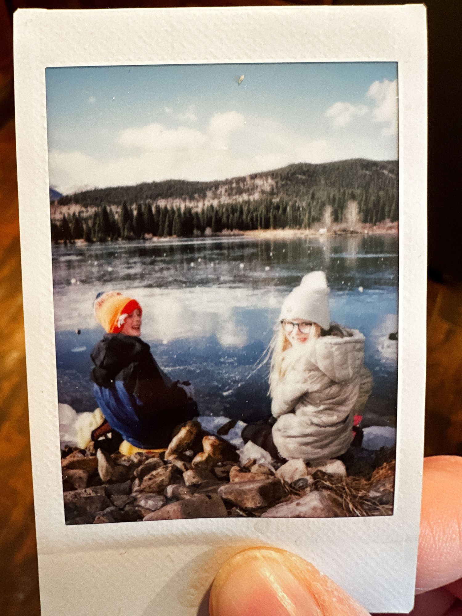 Project 365 - mini polaroid of children playing on frozen lake in mountains.