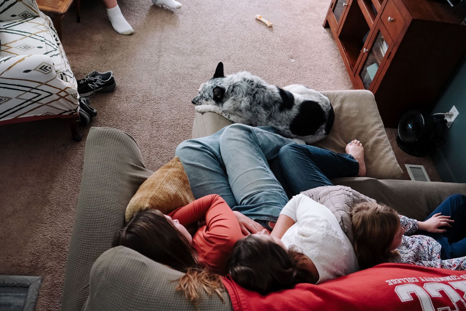 In home Denver documentary portrait of family of four in living room.