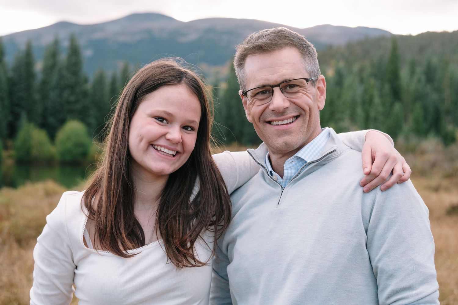 Teen daughter smiling with father.
