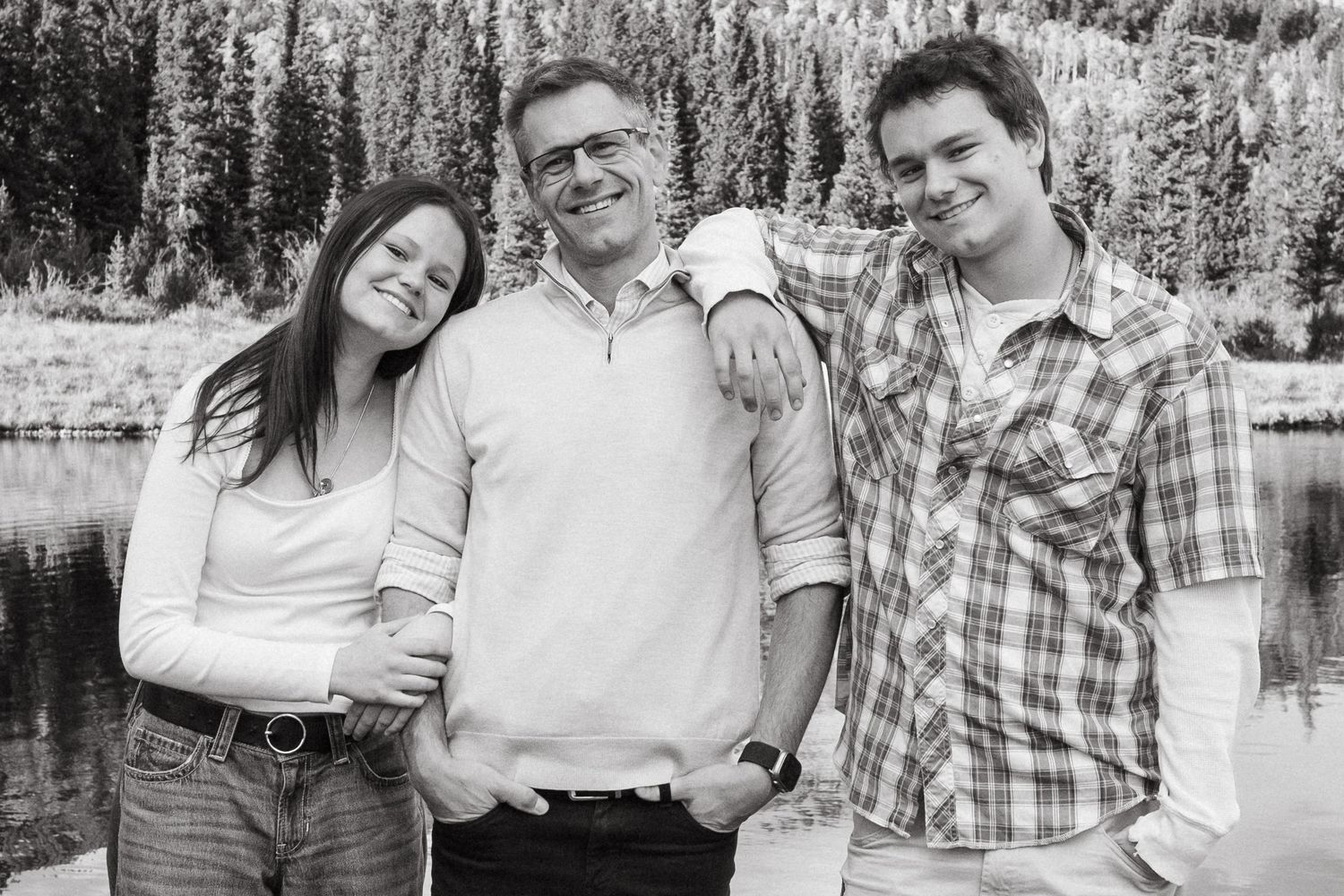 Black and white of father with teenage children in Colorado Mountains.