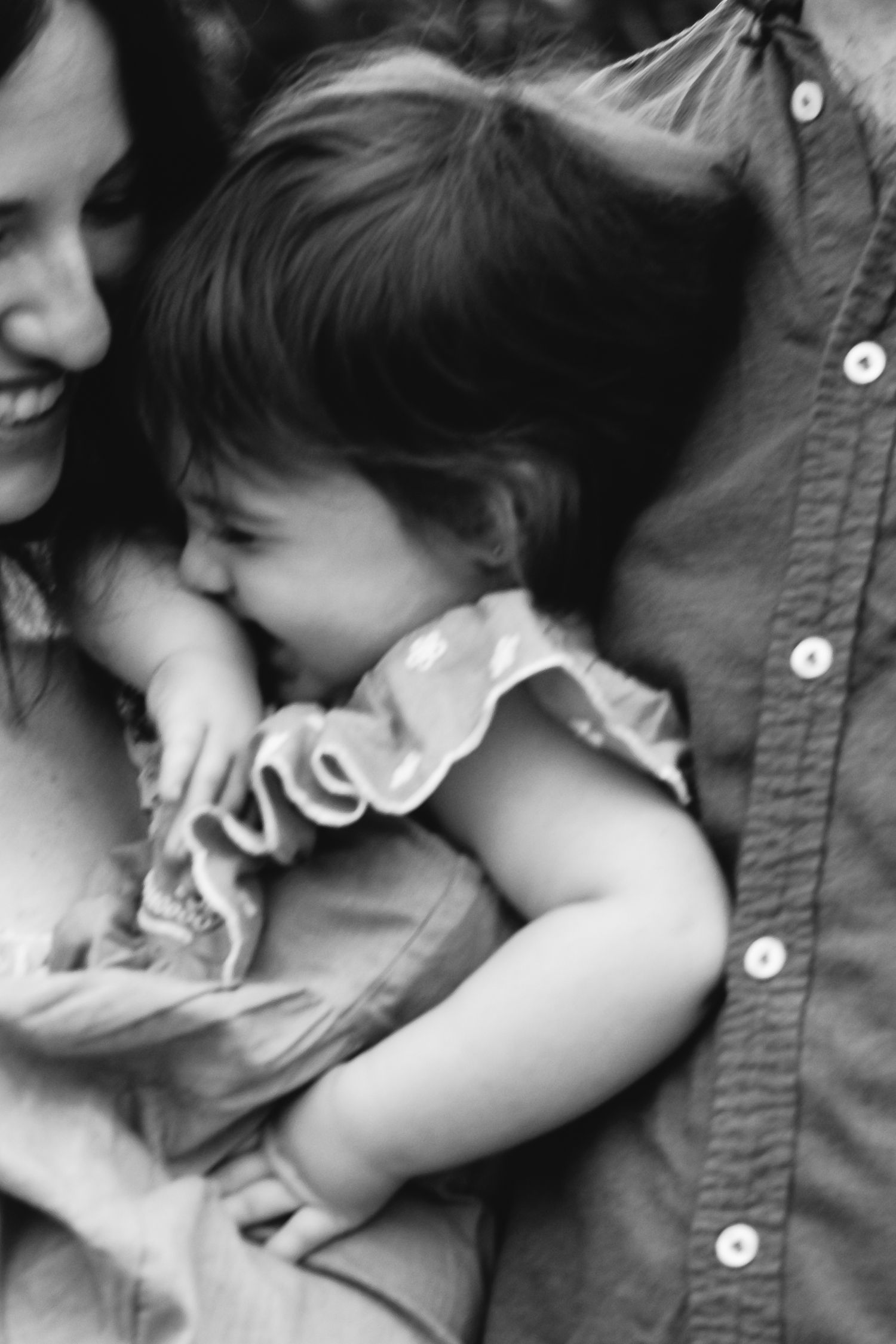 Black and white motion picture close up of mother holding toldder girl.
