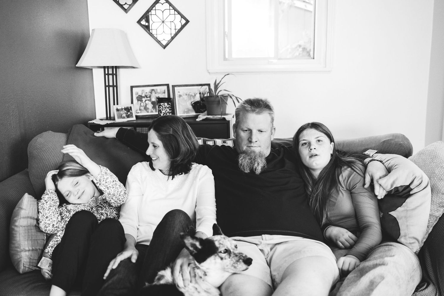In home Denver documentary portrait of family of four in living room.