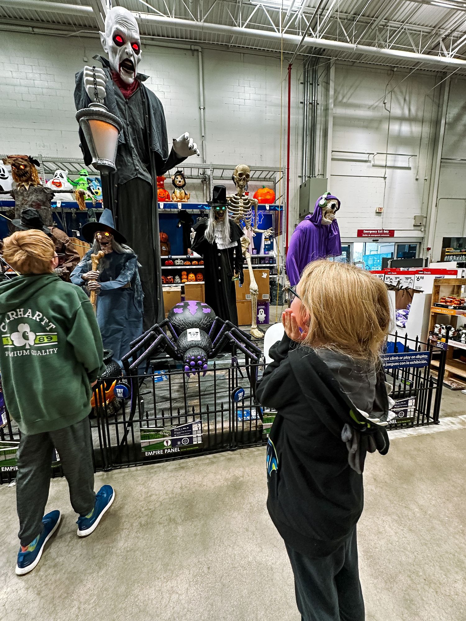 Project 365 photo - child staring up at tall, ominous halloween decoration at hardware store.