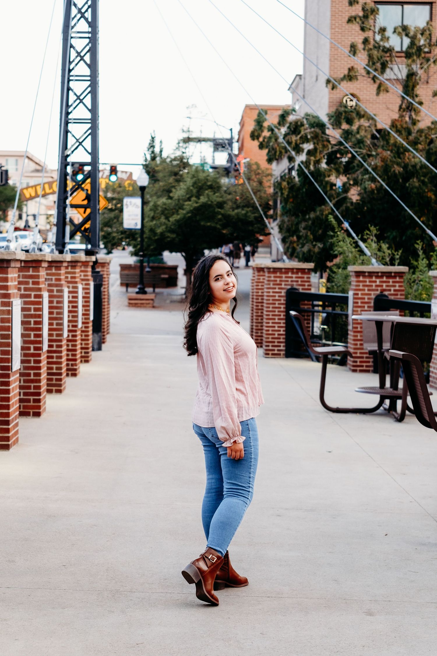 Senior portrait photo of teen walking street in bridge in Golden, Colorado.