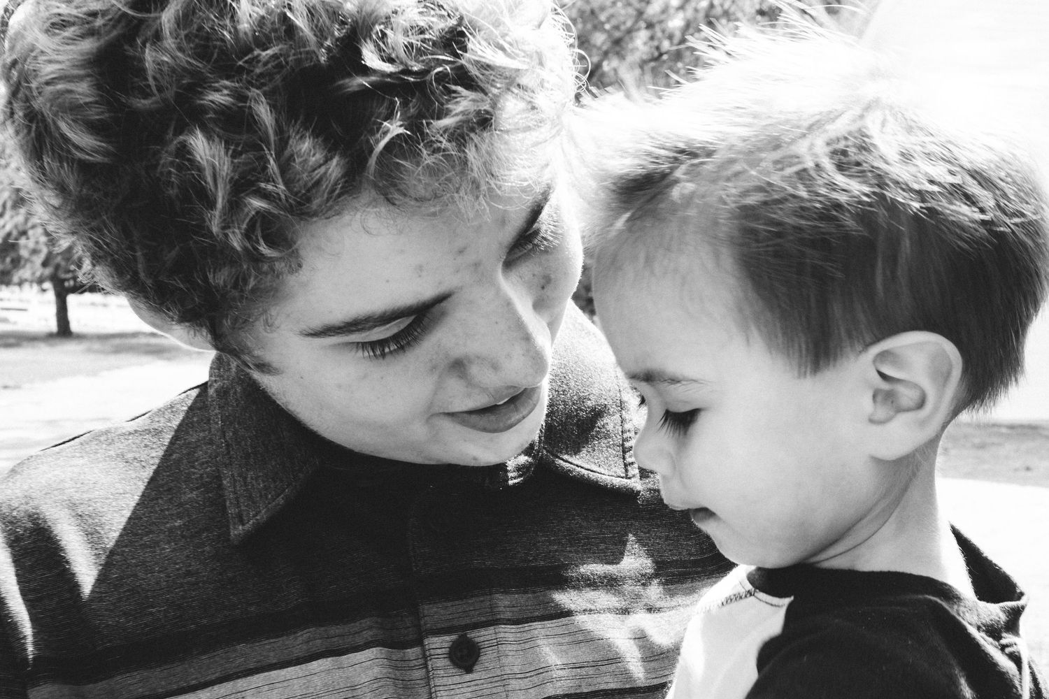 Close up of teen brother and toddler brother.